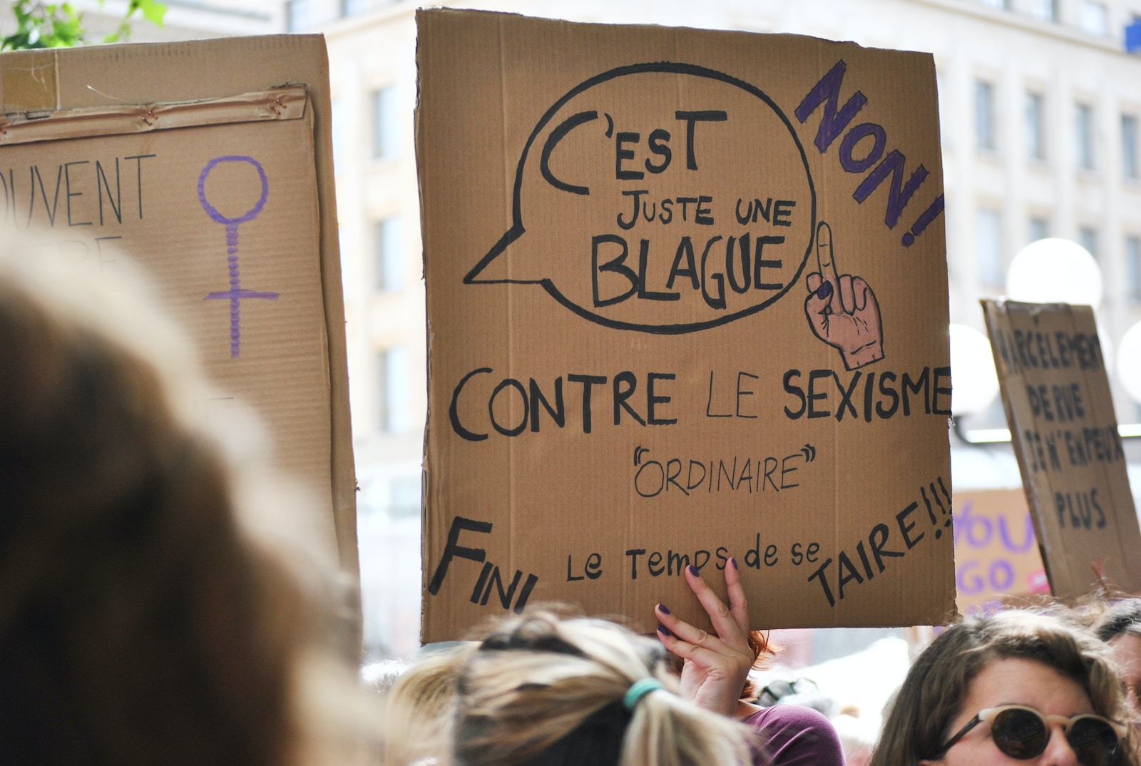 person holding cardboard sign