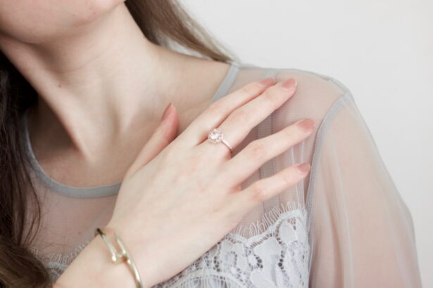 woman in white lace top wearing gold ring